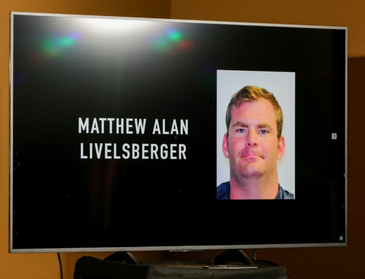 An image of Matthew Alan Livelsberger is displayed on a monitor during a news conference in Las Vegas