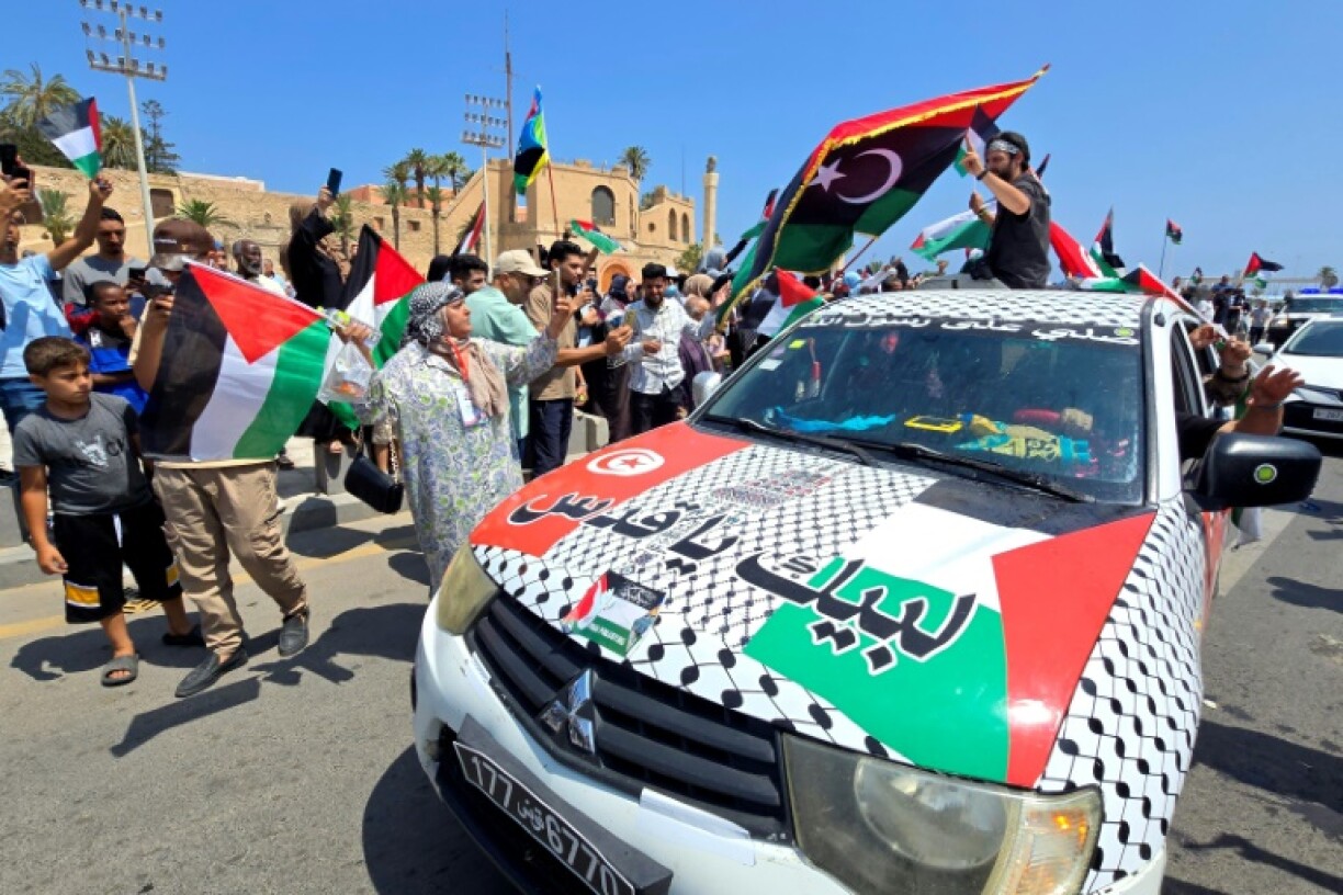 Activists, heading towards Gaza by land with the aim of breaking the siege on the Palestinian territory, are greeted by Libyans in Tripoli's Martyrs Square