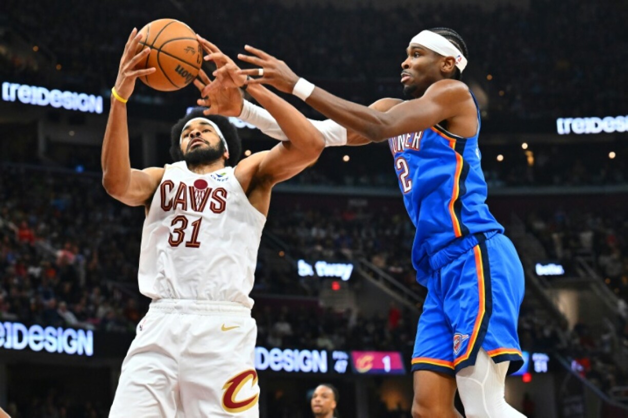 Cleveland's Jarrett Allen, grabbing a rebound over Oklahoma City's Shai Gilgeous-Alexander, scored 25 points to lead the Cavaliers over the Thunder 129-122 in a showdown of the NBA's top clubs