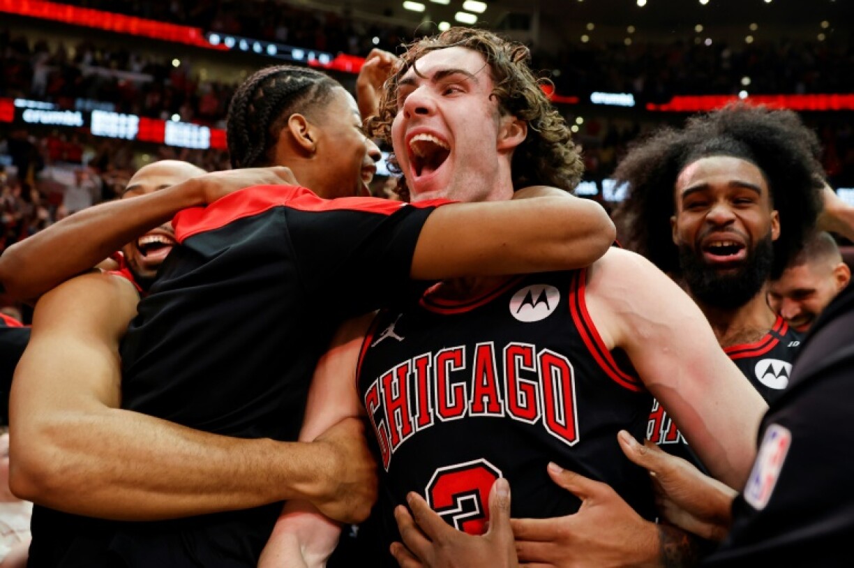 Australian Josh Giddey, center, celebrates with teammates after hitting a half-court shot at the final buzzer to lift the Chicago Bulls over the visiting Los Angeles Lakers