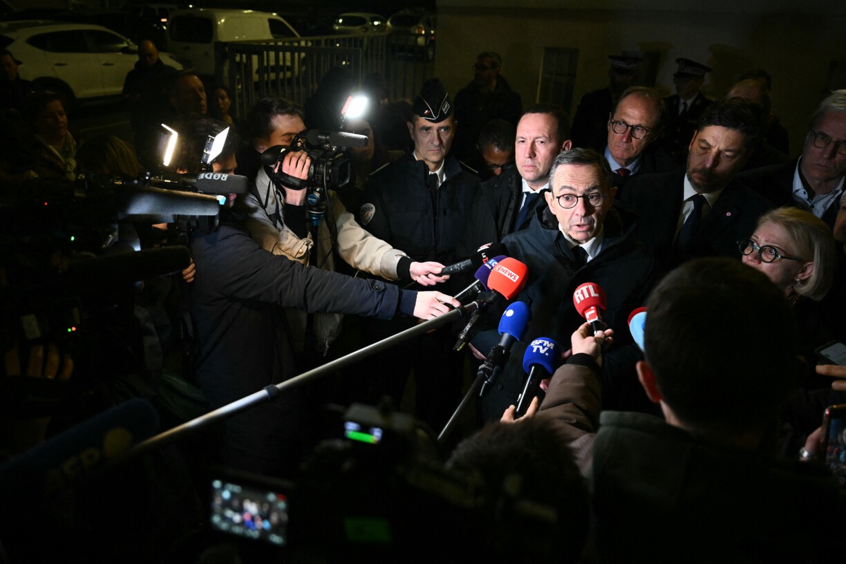 France's Minister of the Interior Bruno Retailleau (Centre R) addresses the press following a knife attack in Mulhouse.