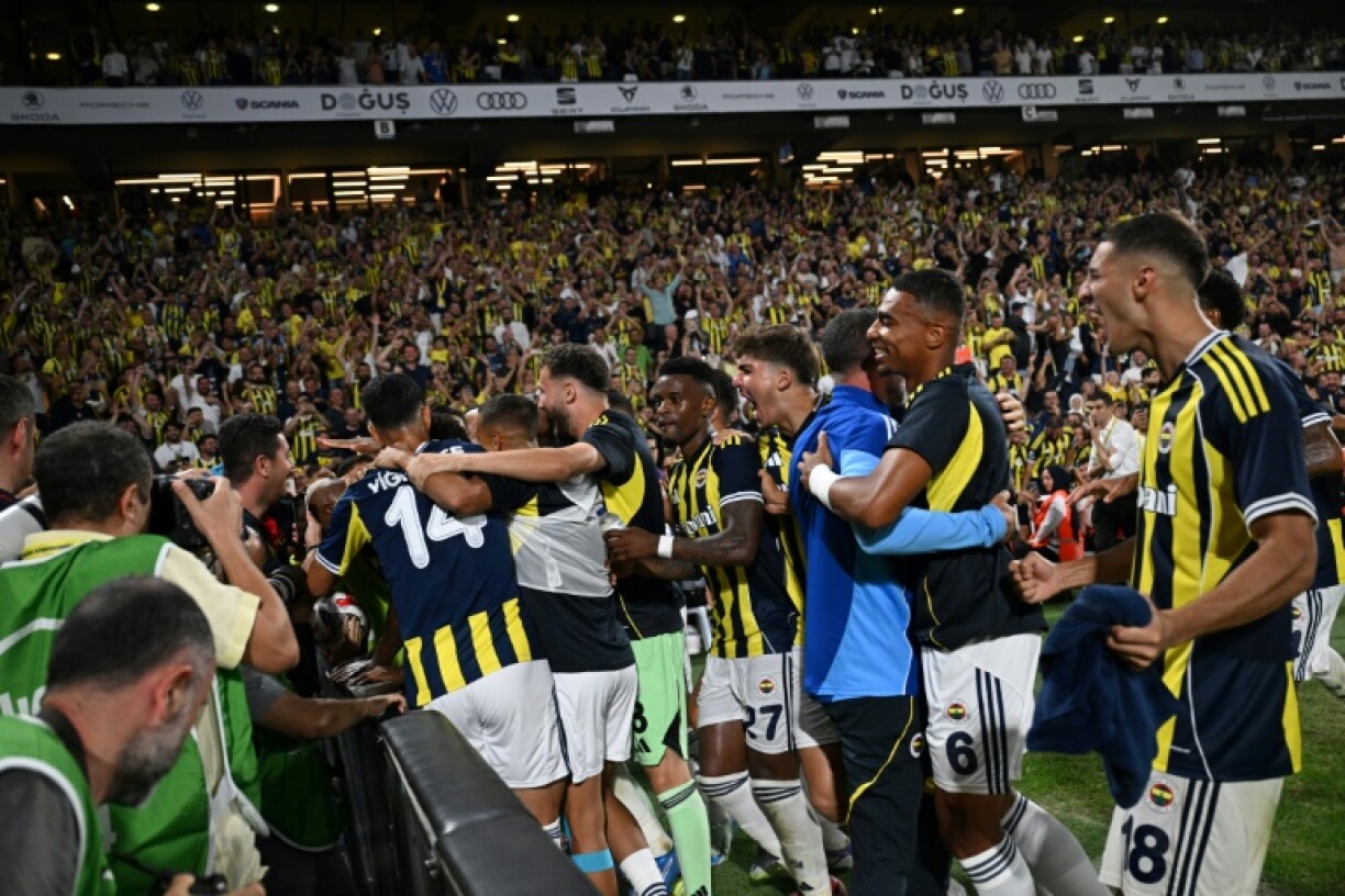 Fenerbahce's Brazilian midfielder Talisca celebrates with teammates after scoring his team's fifth goal against Feyenoord