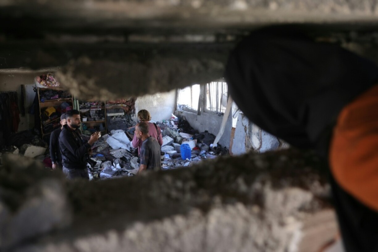 Palestinians inspect the damage after an Israeli strike on a school housing displaced Palestinians in Jabalia, northern Gaza