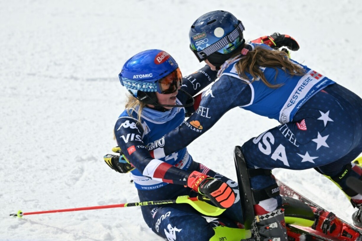 Mikaela Shiffrin (L) is hugged by US teammate Paula Moltzan after completing her historic 100th World Cup victory