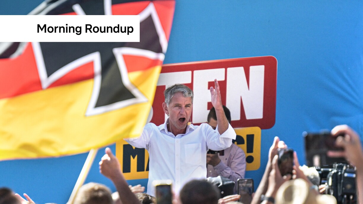 AfD top candidate Björn Höcke speaks at an AfD election rally behind a German flag with the Iron Cross.