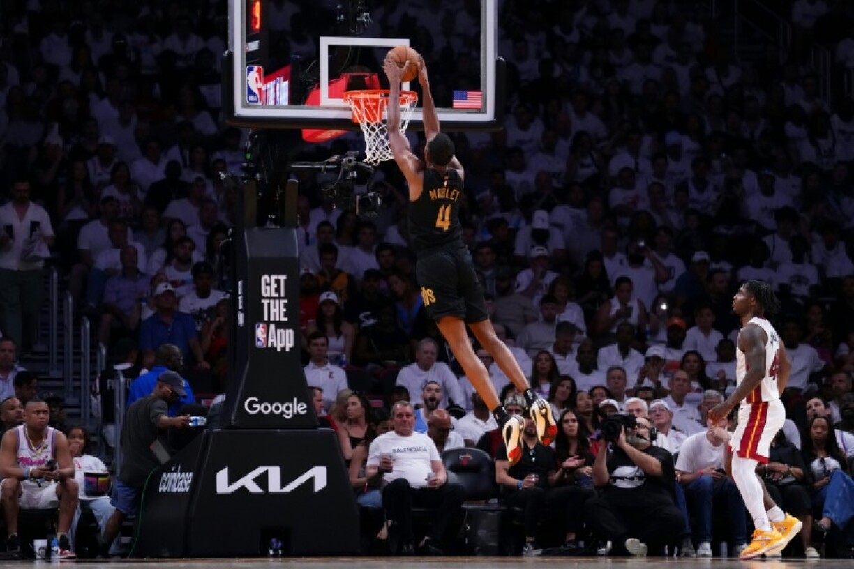 Evan Mobley of the Cleveland Cavaliers dunks the ball against Davion Mitchell in the Cavs' victory over the Miami Heat in game three of their NBA playoff series