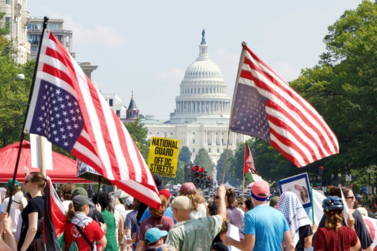 Demonstrators hold inverted US flags near the US Capitol during the