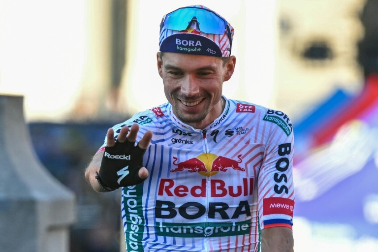 Primoz Roglic waves to spectators at the 2025 Tour de France presentation gala