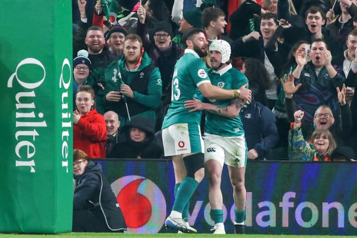 Ireland's Australia-born full-back Mack Hansen (R) touched down under the posts twice inside the first quarter of an hour
