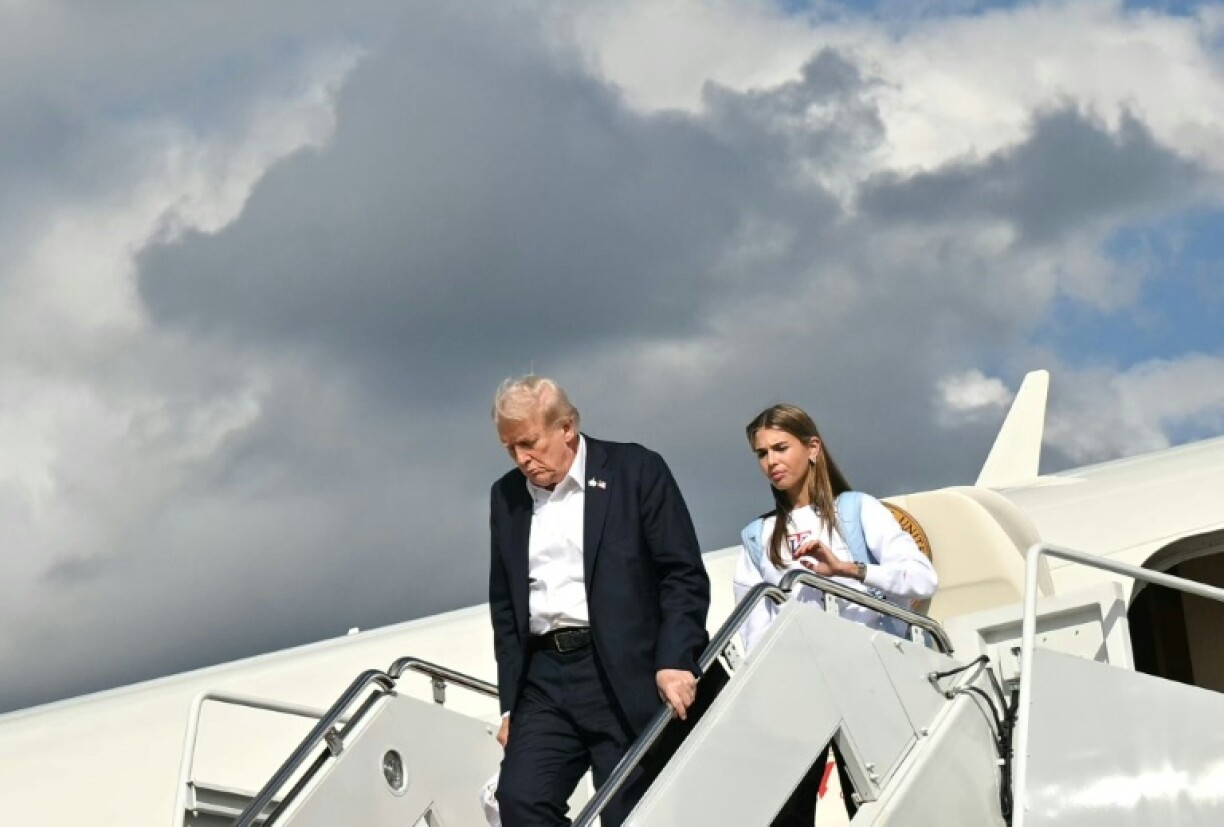 US President Donald Trump and his granddaughter Kai Trump step off Air Force One after attending the Ryder Cup in September 2025