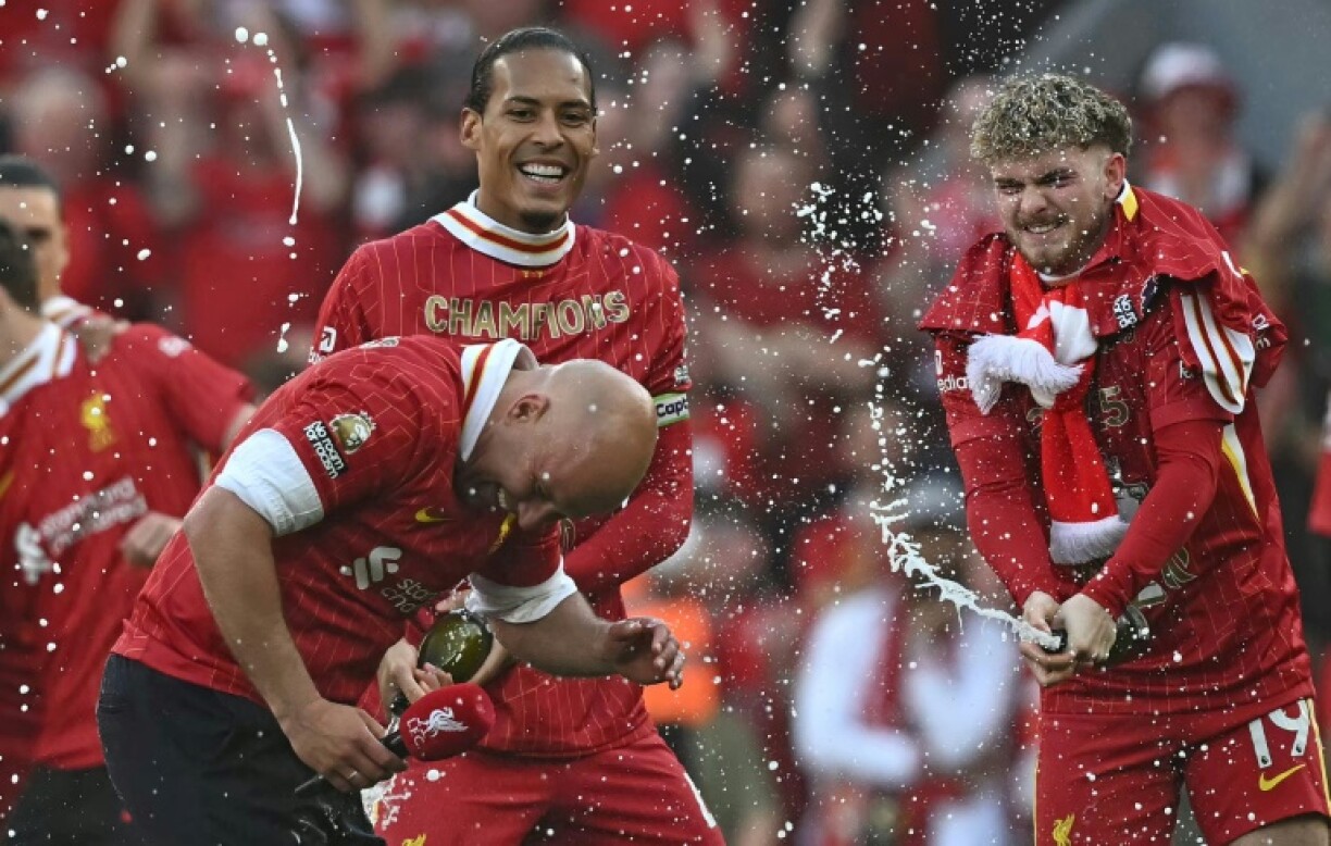Liverpool manager Arne Slot celebrates winning the Premier League title with his players