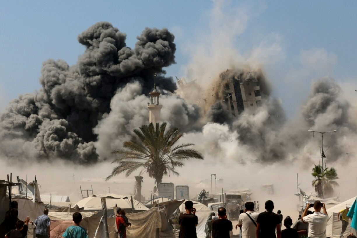 Smoke billows from Israeli strikes that brought down a high-rise tower in Gaza City on Friday