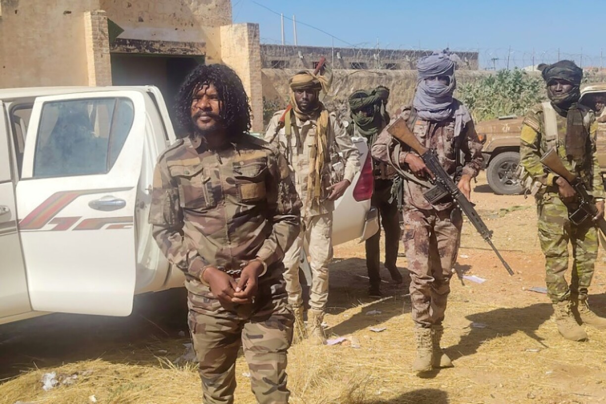 A photo released by the RSF purportedly shows its members detaining a fighter known as Abu Lulu (L) who was seen in execution videos from El-Fasher