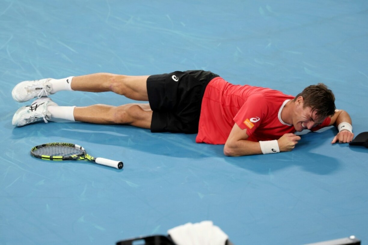 Belgium's Raphael Collignon overcomes cramps to beat Australia's Alex de Minaur in Sydney