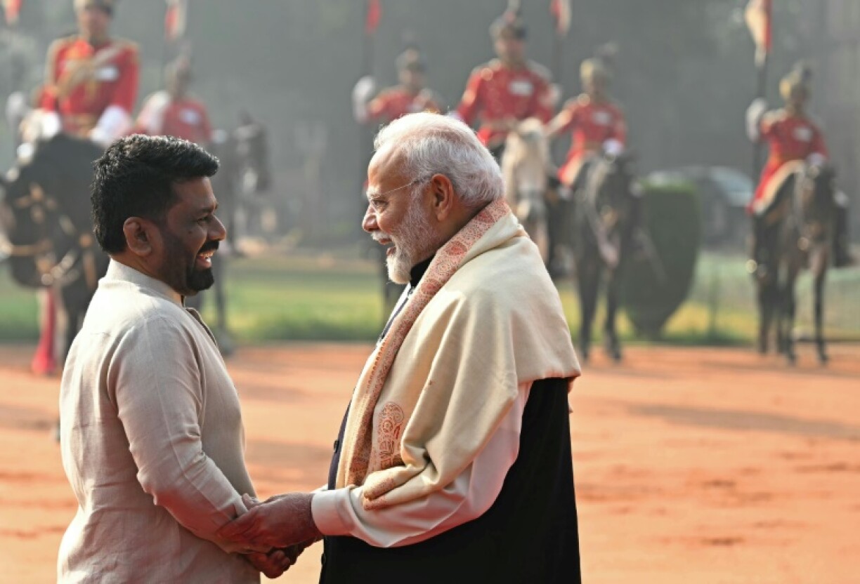 Sri Lanka's President Anura Kumara Dissanayake (L) speaks with India's Prime Minister Narendra Modi