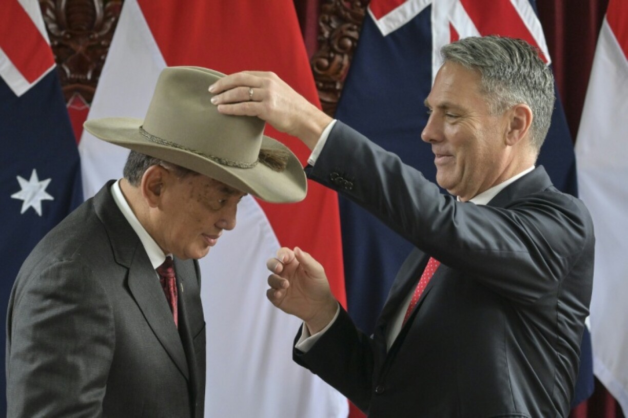 Indonesia's Defence Minister Sjafrie Sjamsoeddin received a hat from his Australian counterpart Richard Marles