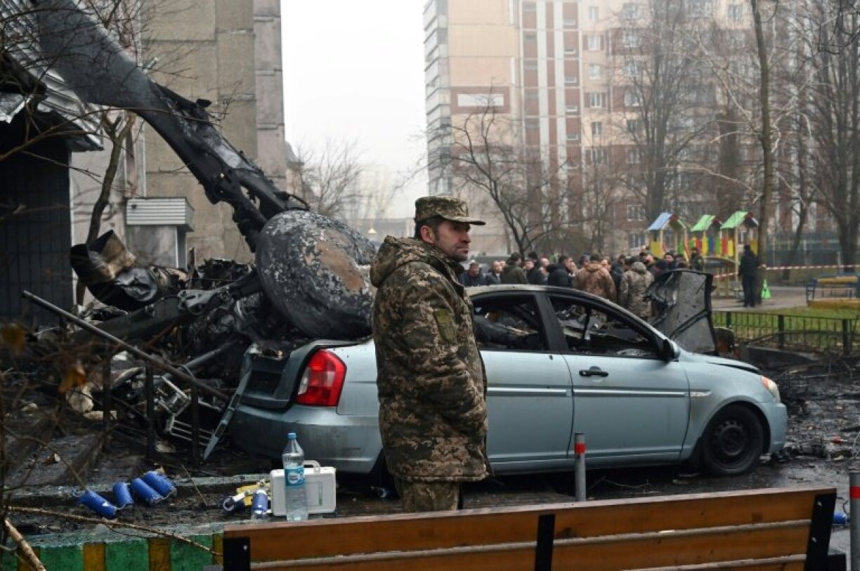 A military serviceman stands at the site of the crash near a kindergarten outside the capital Kyiv