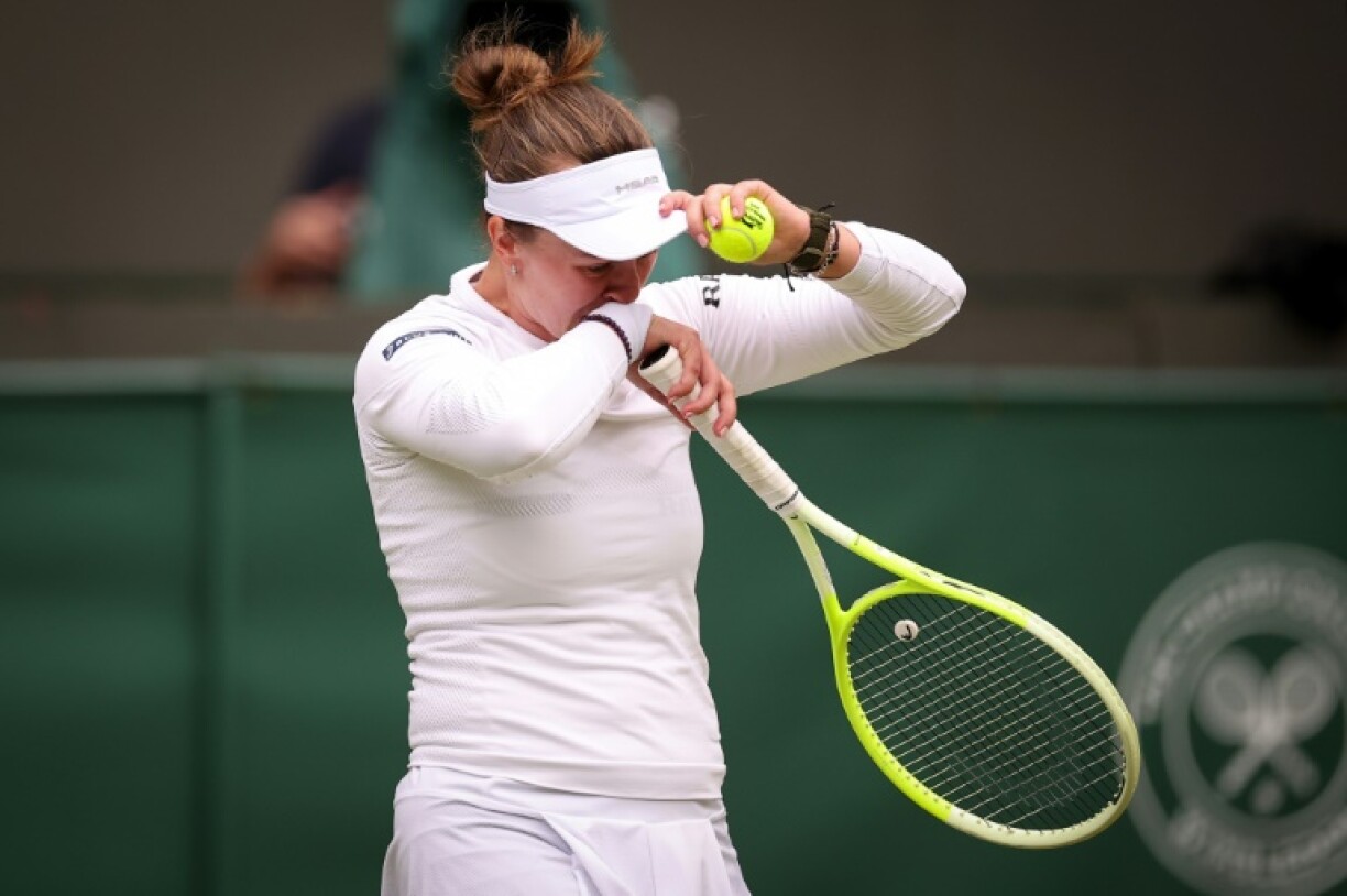 Barbora Krejcikova cries as she prepares to serve at Wimbledon