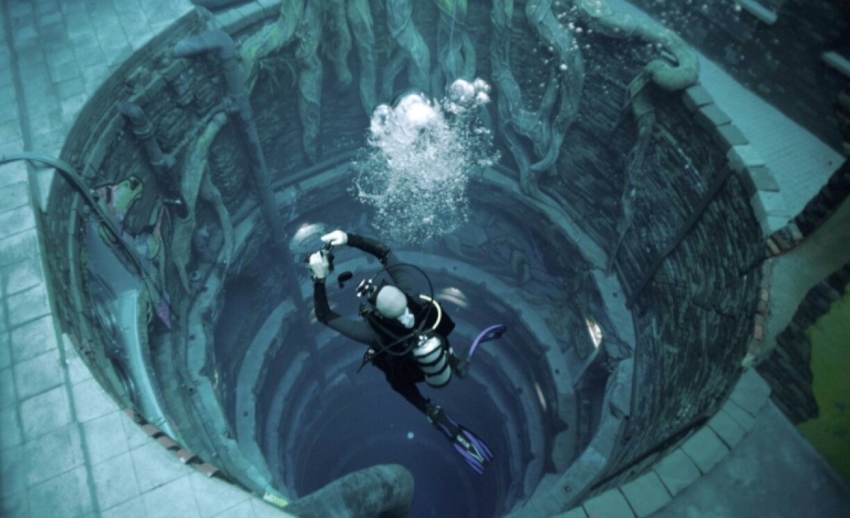 A diver experiences Deep Dive Dubai, the deepest swimming pool in the world