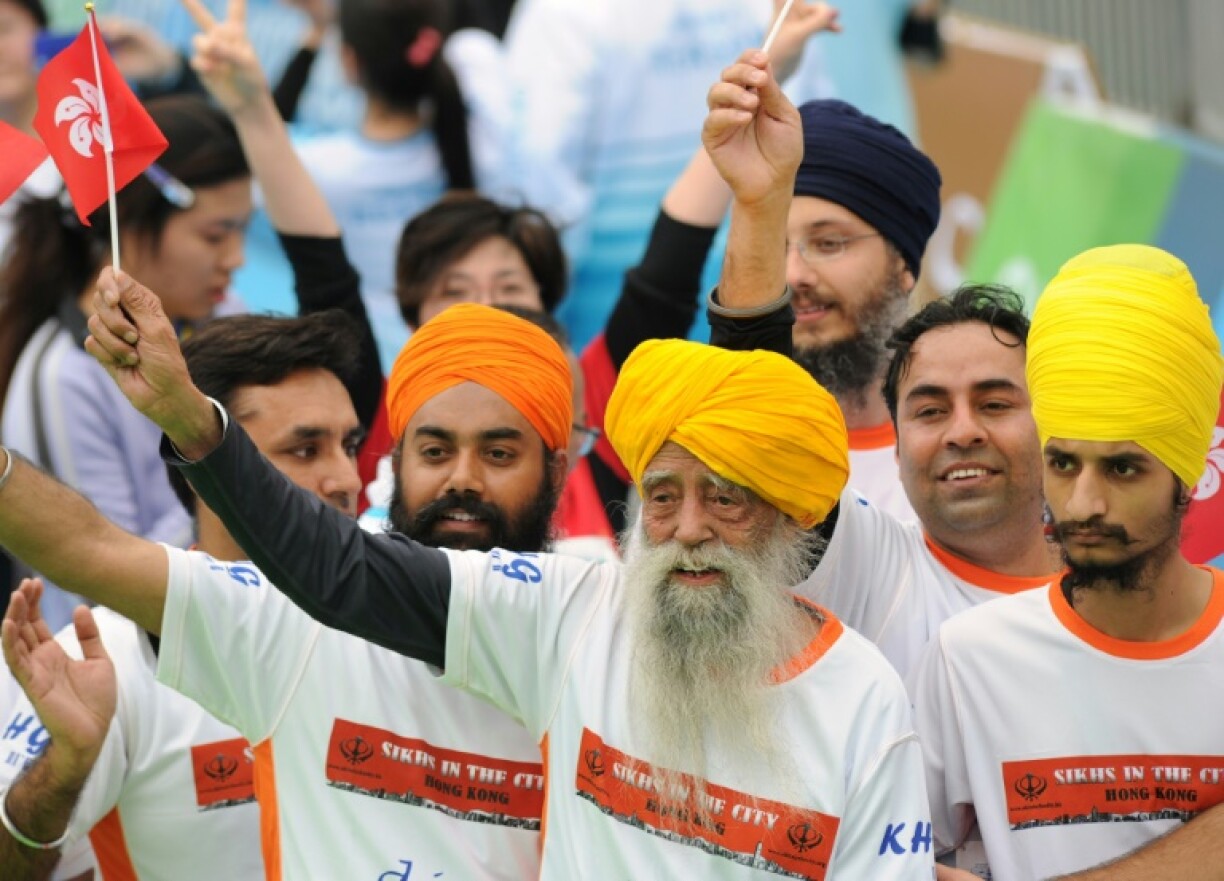 Fauja Singh (front), seen here after finishing a 10km race in Hong Kong in 2013, has died at the age of 114