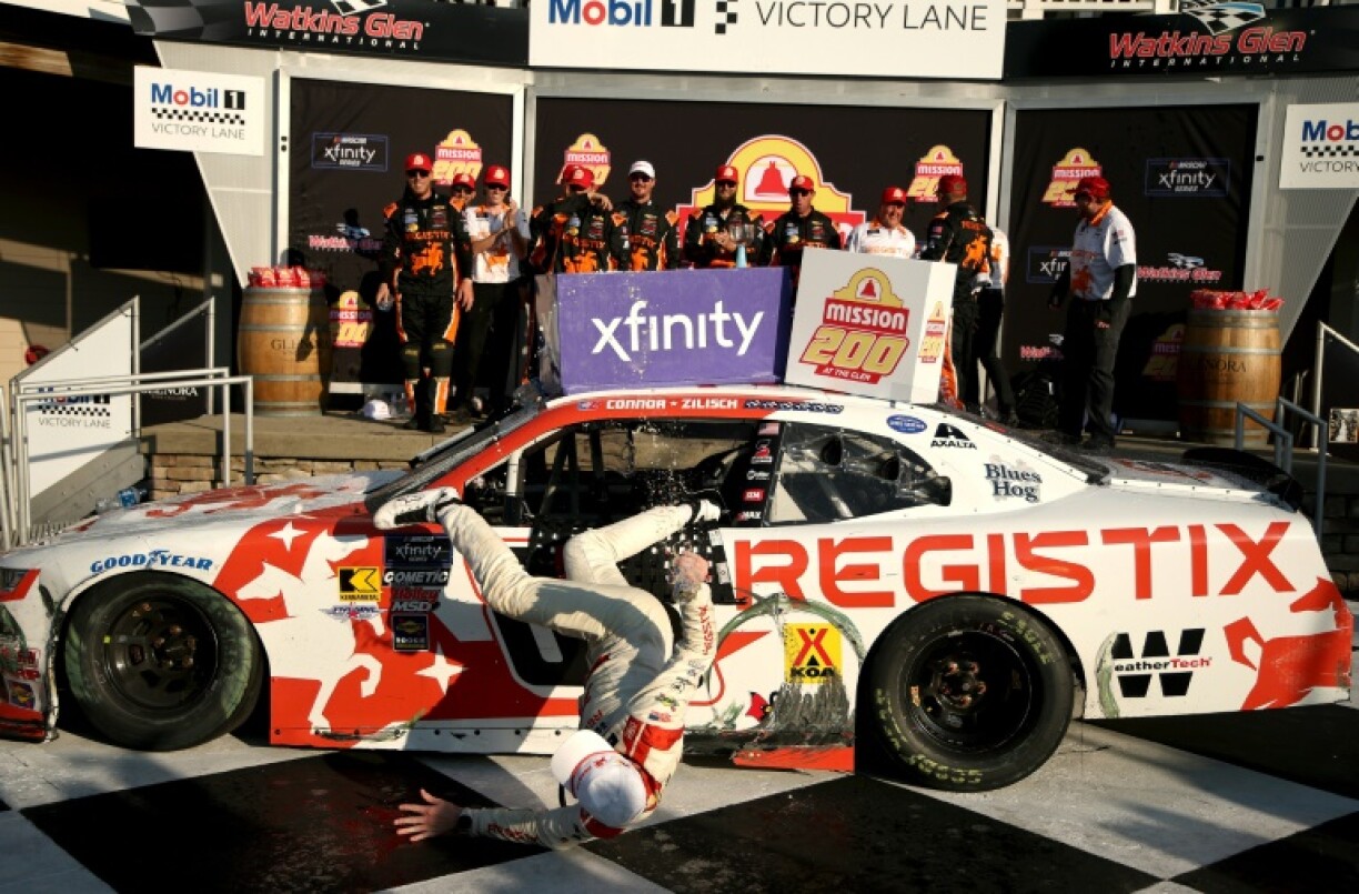 Driver Connor Zilisch slips and falls off his car in victory lane after winning the NASCAR Xfinity Series Mission 200 at Watkins Glen International