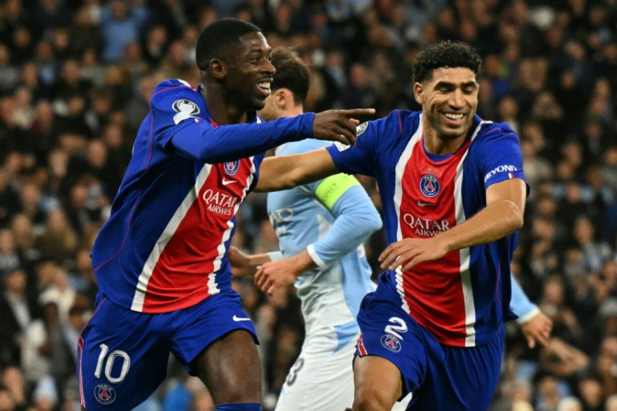 Ousmane Dembele (L) celebrates with Achraf Hakimi after scoring Paris Saint-Germain's second goal in their 4-2 win away to Manchester City