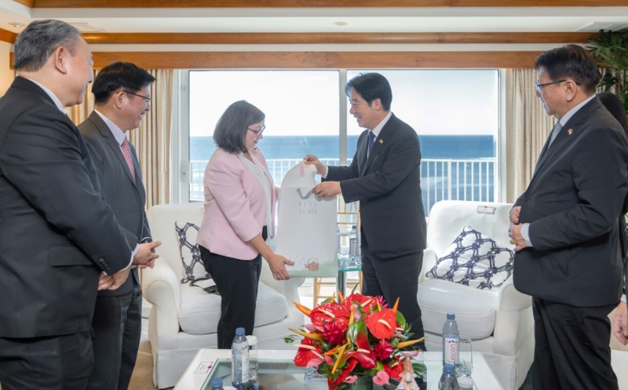 Taiwanese President Lai Ching-te (centre R) presentis a souvenir to Ingrid Larson, managing director of the American Institute in Taiwan