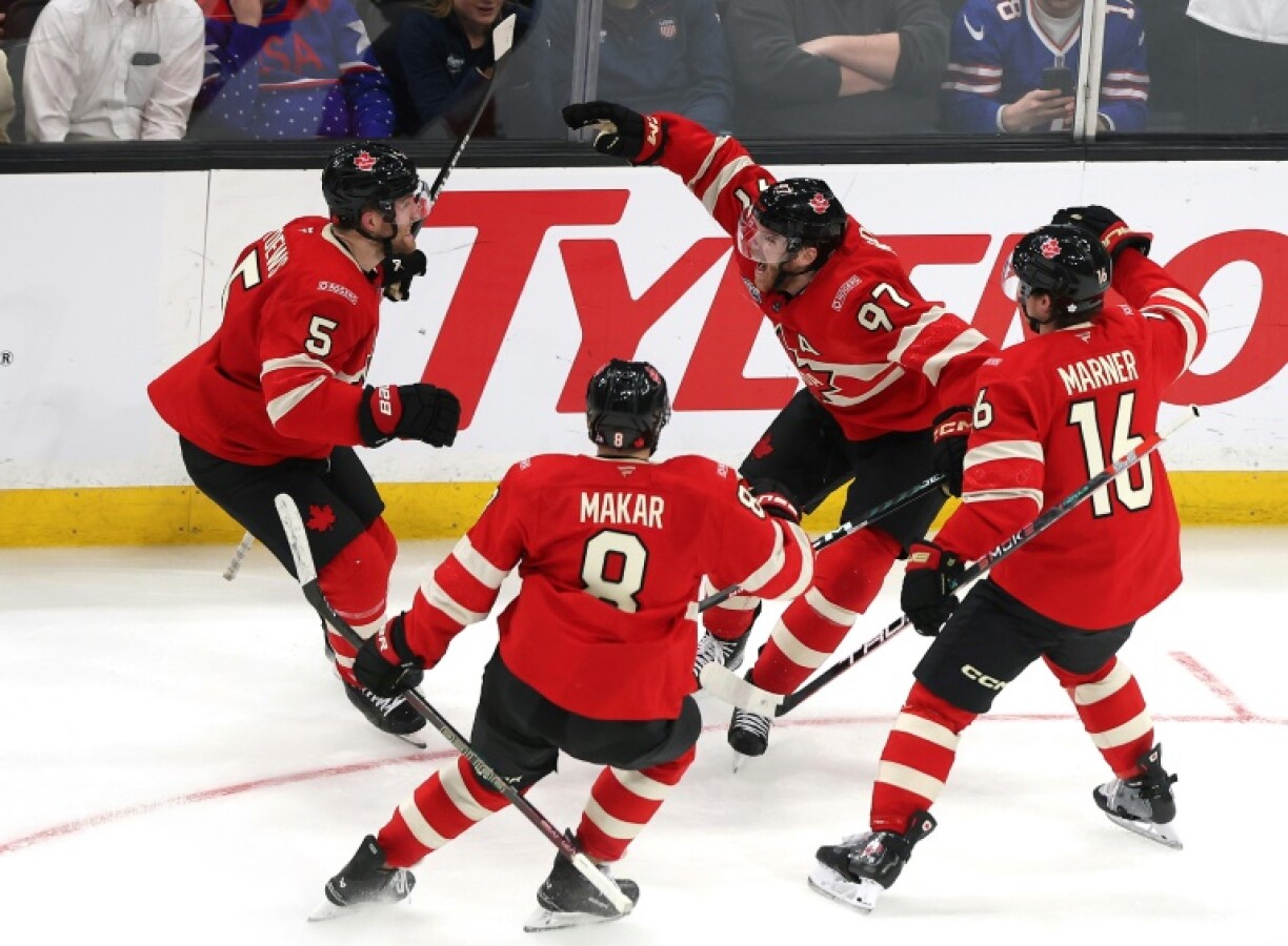 Canada's Connor McDavid, backj right, celebrates with teammates aftr scoring the title-winning goal in overtime to defeat the United States 3-2 in the Four Nations Face-Off final