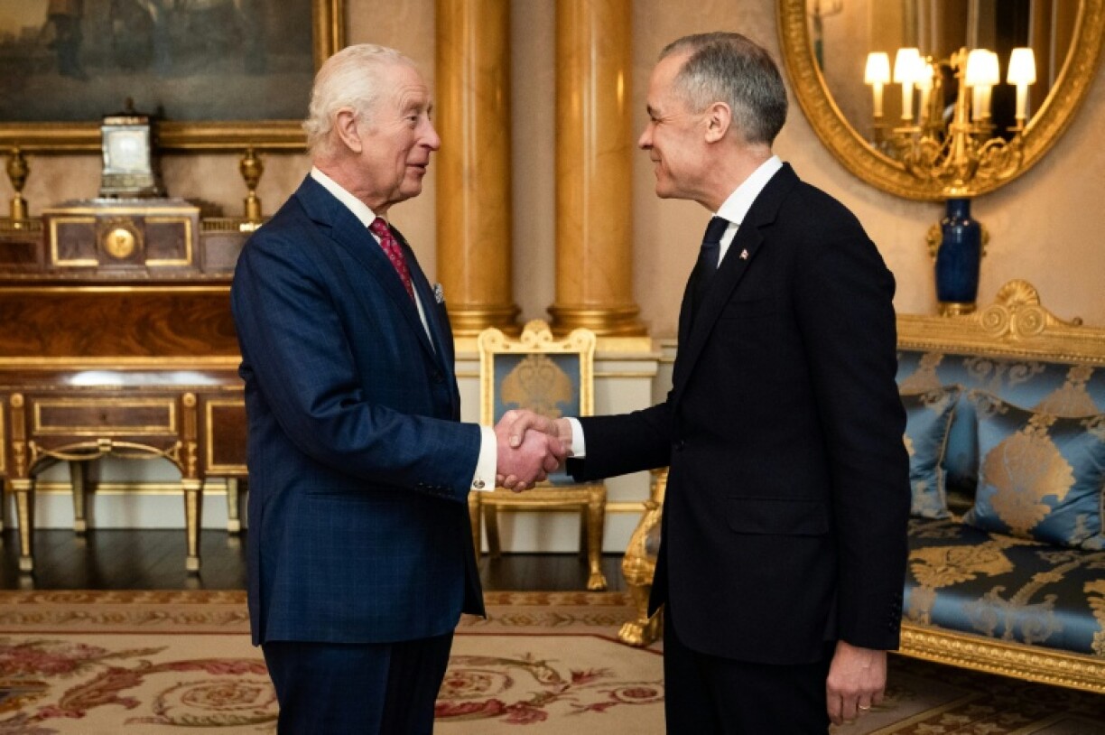 Britain's King Charles -- who is also head of state in Canada -- was pictured smiling as he welcomed Carney