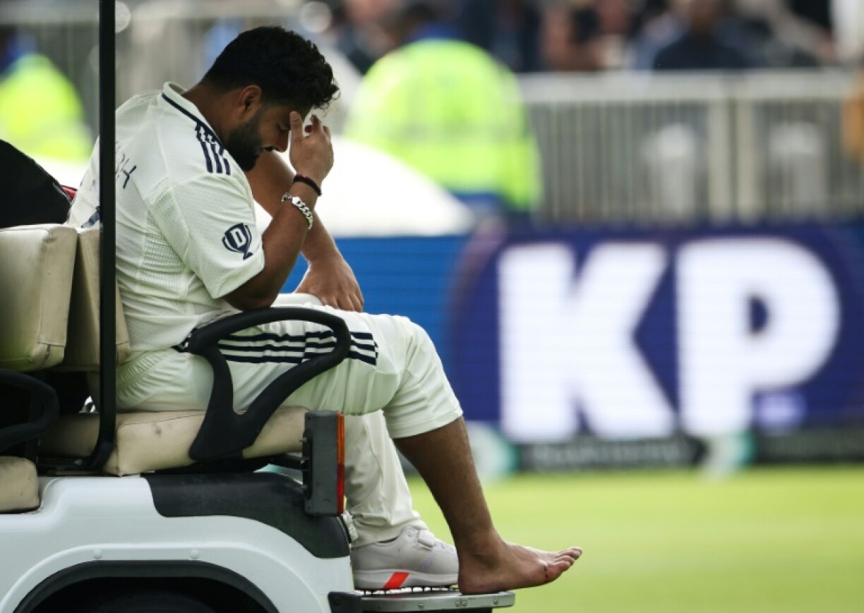 India's Rishabh Pant reacts as he leaves the field in a buggy after retiring hurt on 37 with a foot injury