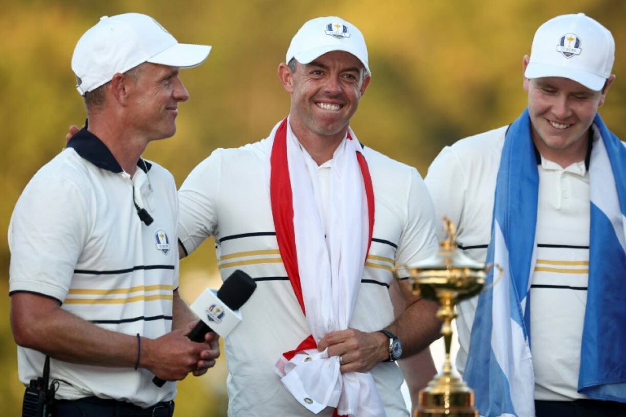 Europe captain Luke Donald, left, celebrates with players Rory McIlroy, center, and Robert MacIntyre after Europe's 15-13 victory over the United States in the 45th Ryder Cup