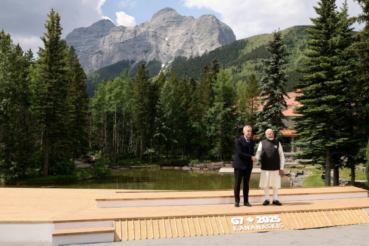 Canadian Prime Minister Mark Carney greets Indian Prime Minister Narendra Modi before a group photo during the Group of Seven summit ain Kananaskis, Alberta, Canada