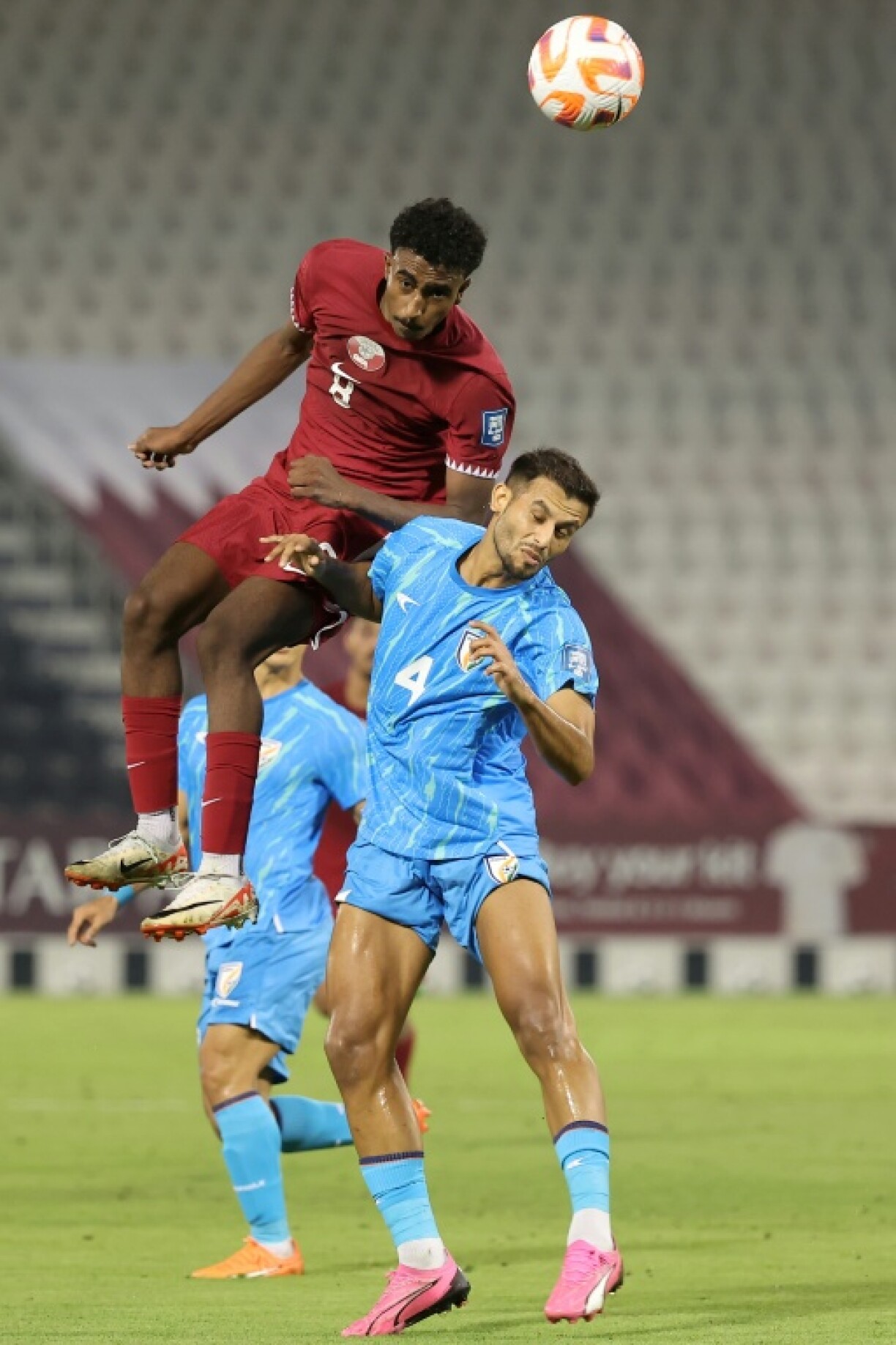 Qatar midfielder Ibrahim Al-Hassan outjumps India defender Anwar Ali