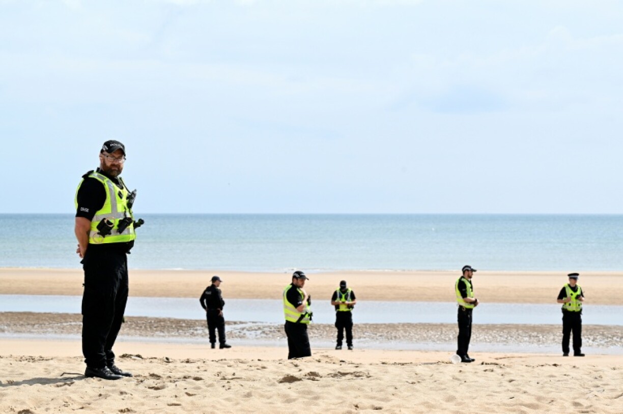 British police officers stand on duty Balmedie Beach, and the sand dunes leading to the course at Trump International Golf Links, in Aberdeenshire north east Scotland ahead of a visit by US President Trump