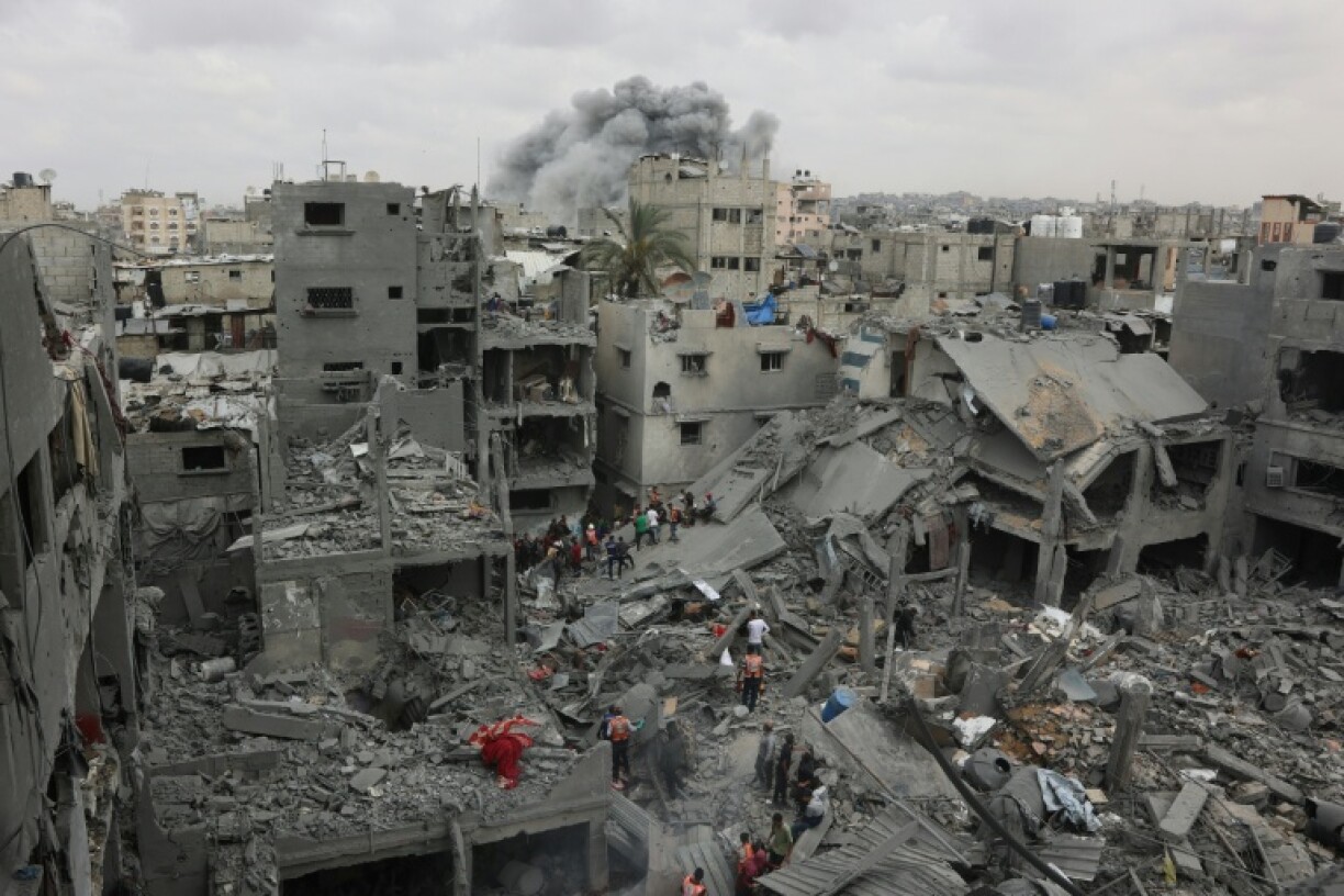 Palestinian rescuers search the rubble of a four-storey residential block in Gaza City for survivors after it was flattened by an Israeli strike, killing at least 23 people, according to the civil defence agency.