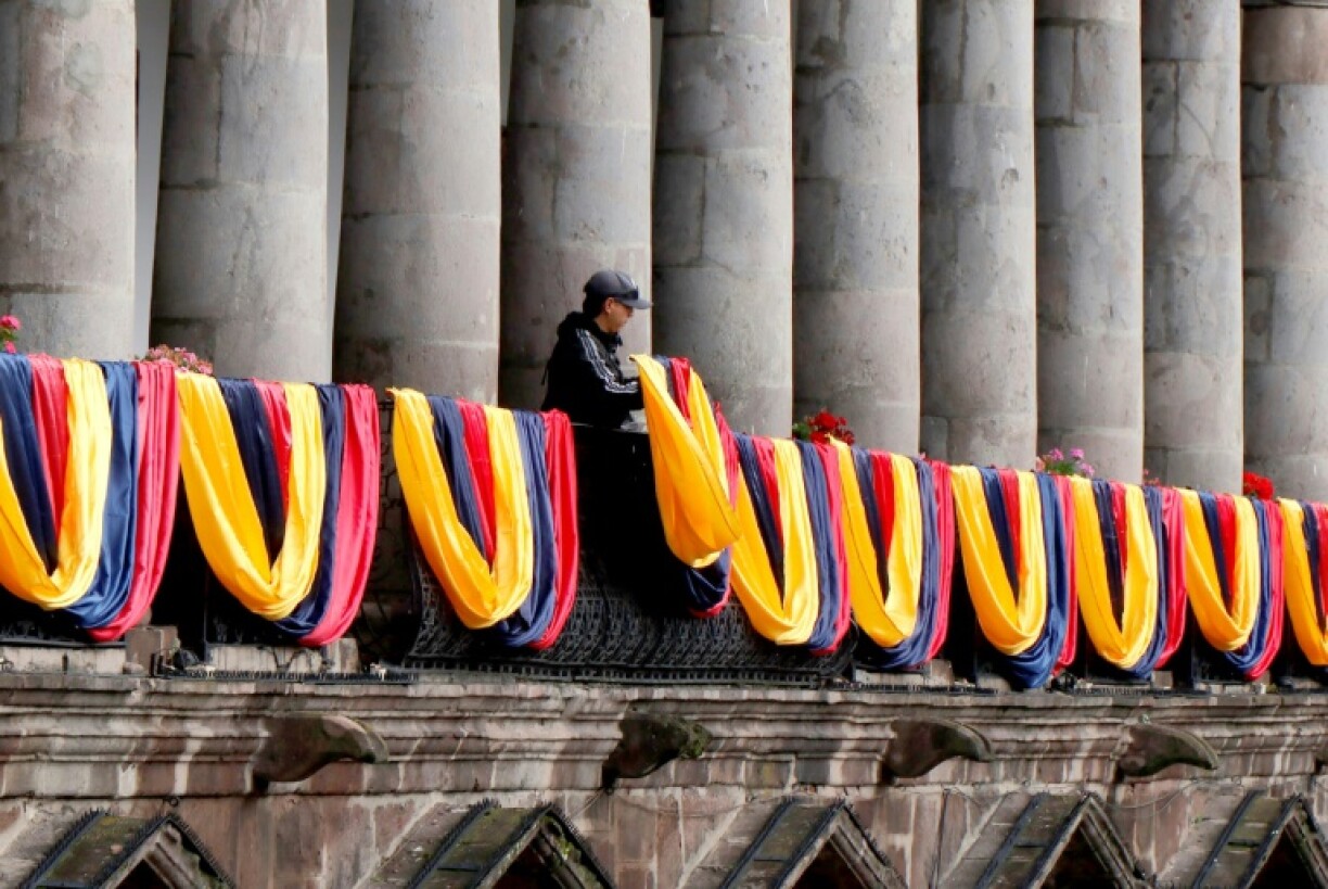 Ecuadoran flags are draped from a railing at the government palace in the capital city of Quito on January 5, 2025