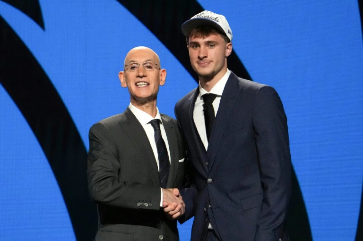 Cooper Flagg shakes hands with NBA Commissioner Adam Silver after being selected first overall by the Dallas Mavericks at the NBA draft