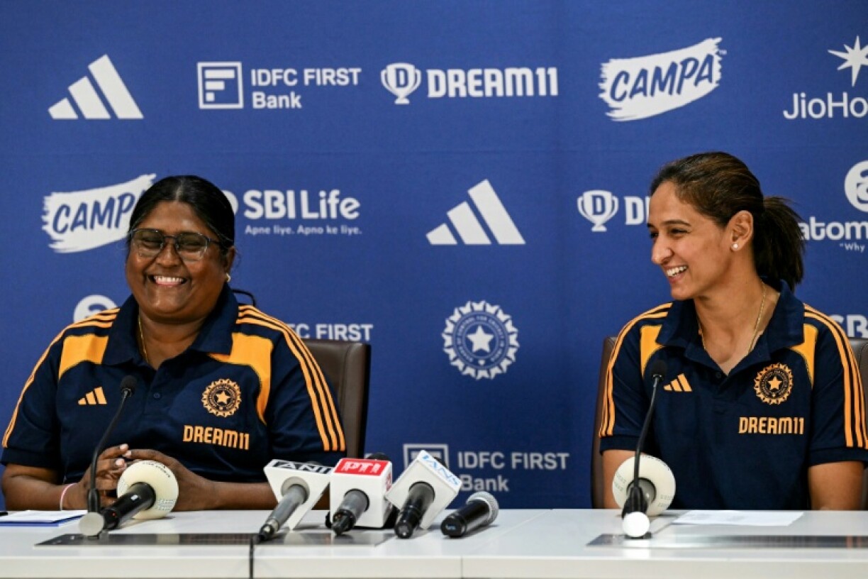 India's captain Harmanpreet Kaur (R) and chief selector Neetu David, with the Dream11 sponsorship clearly seen
