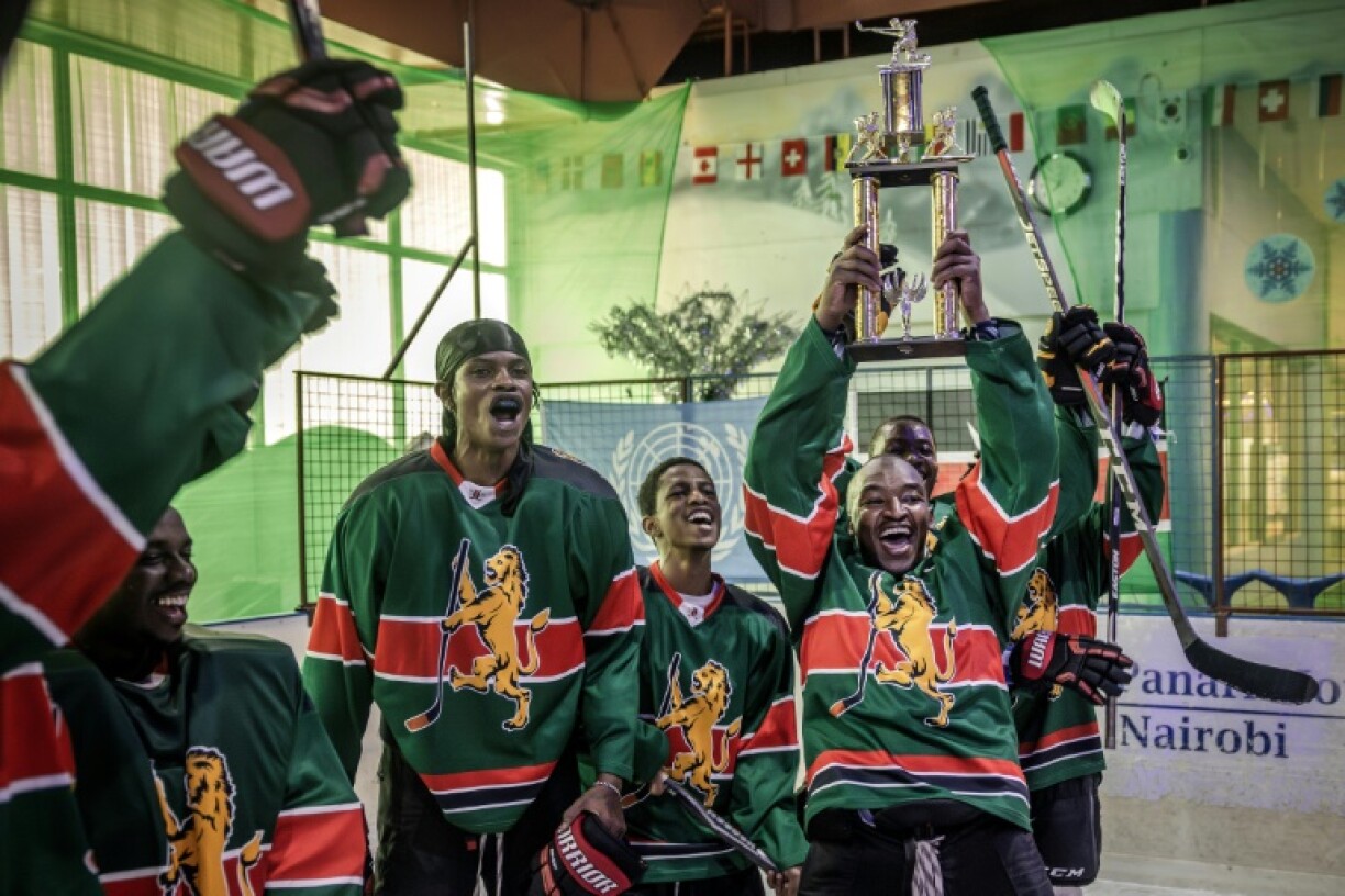 Team captain Benjamin Mburu holding the trophy after the Ice Lions won a local friendly league