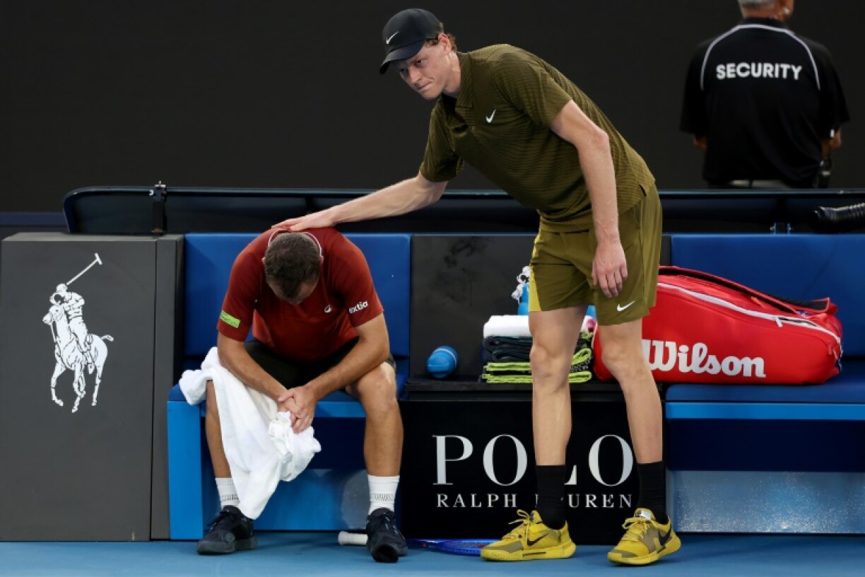 Jannik Sinner tente de réconforter Hugo Gaston alors que le Français abandonne sur blessure au premier tour de l'Open d'Australie, le 20 janvier 2026 à Melbourne