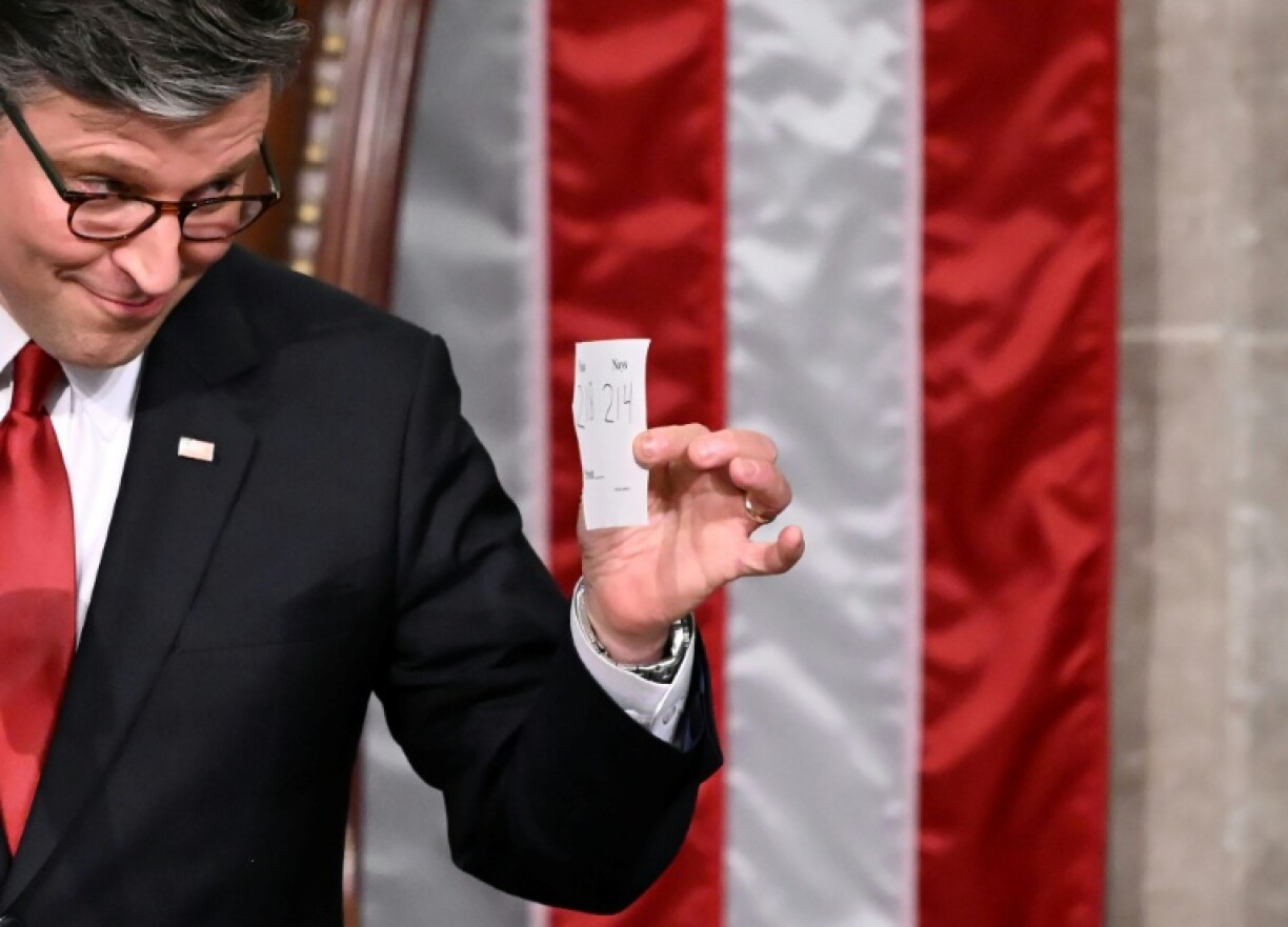 US House Speaker Mike Johnson shows the final tally of the vote on President Donald Trump's tax bill on the floor of the House of Representatives
