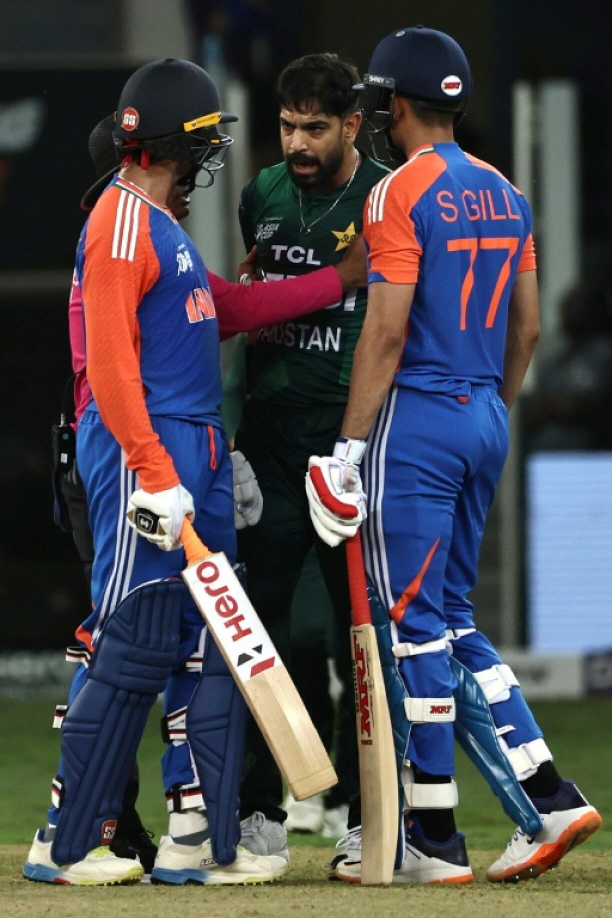 Pakistan's Haris Rauf (C) and India's Abhishek Sharma (L) kept up the spice with a lively exchange