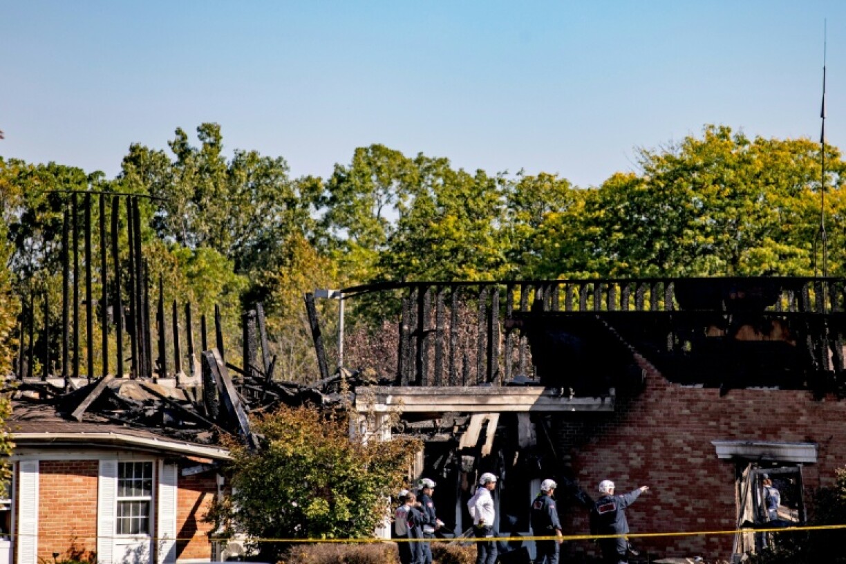 Police survey the remains of the Church of Jesus Christ of Latter-day Saints in Grand Blanc, Michigan, following the attack