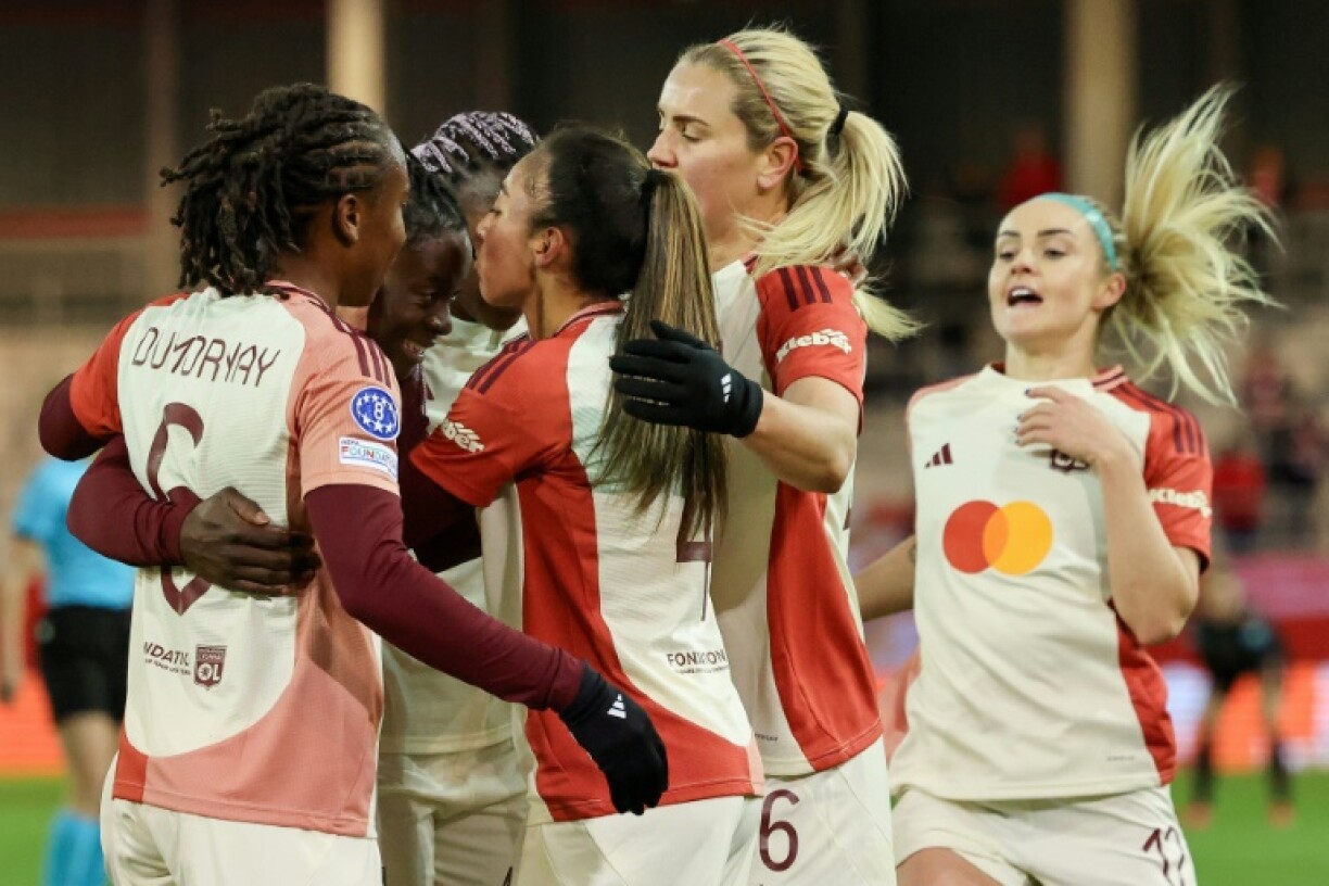 Golden girl: Lyon's Tabitha Chawinga (2nd L) celebrates scoring the opening goal