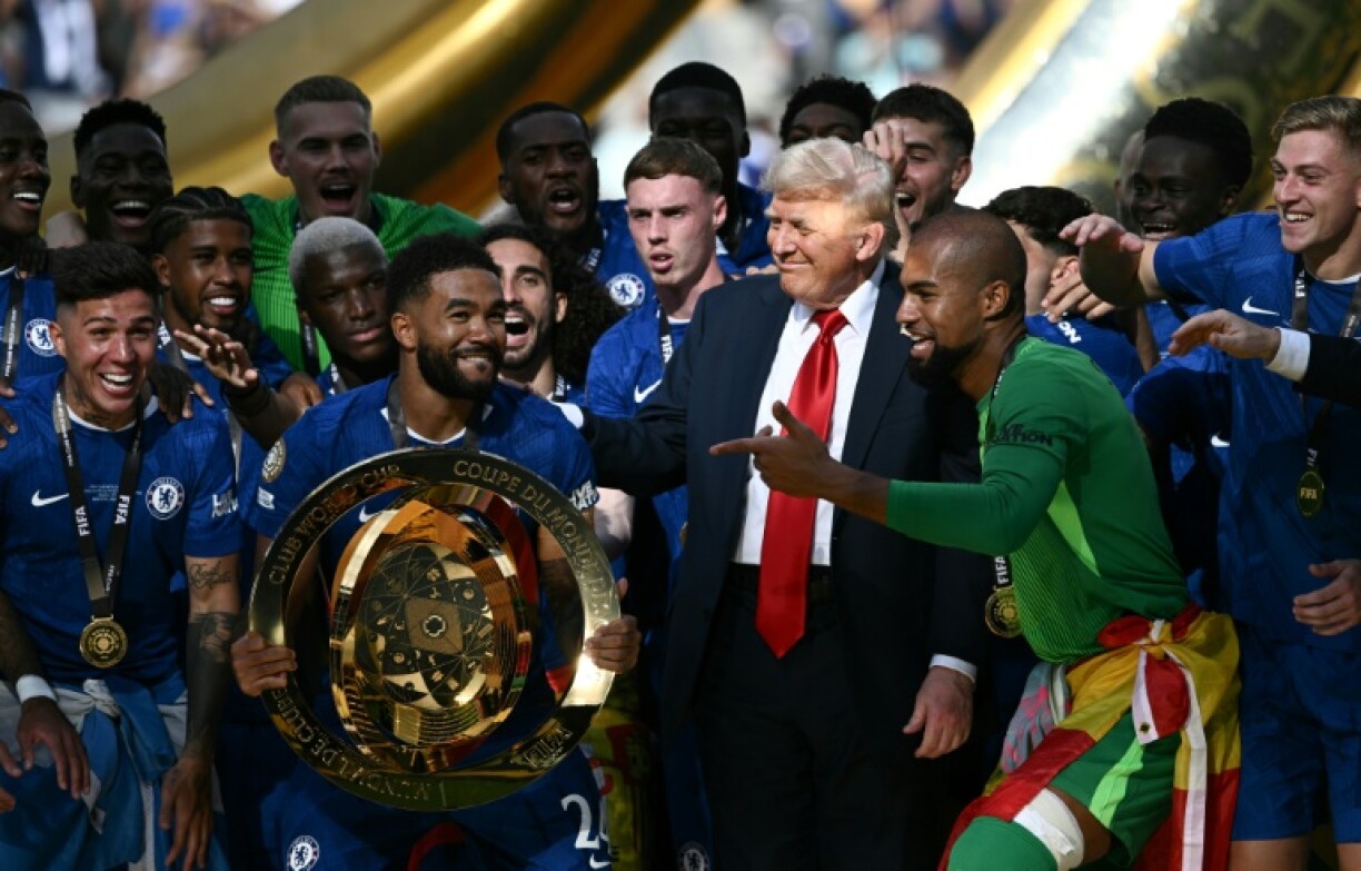 Chelsea captain Reece James holds the Club World Cup trophy alongside US President Donald Trump