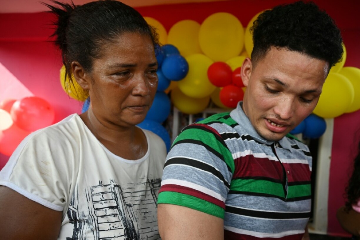 Mervin Yamarte (R), a Venezuelan migrant repatriated from a prison in El Salvador, is welcomed by his mother, Mercedes Yamarte, upon arrival at his home in Maracaibo, Venezuela