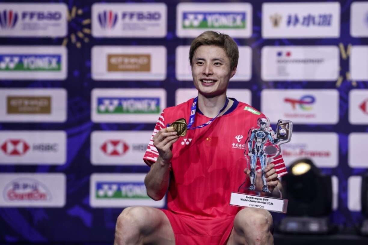 Chinese world champion Shi Yuqi celebrates with his trophy in Paris