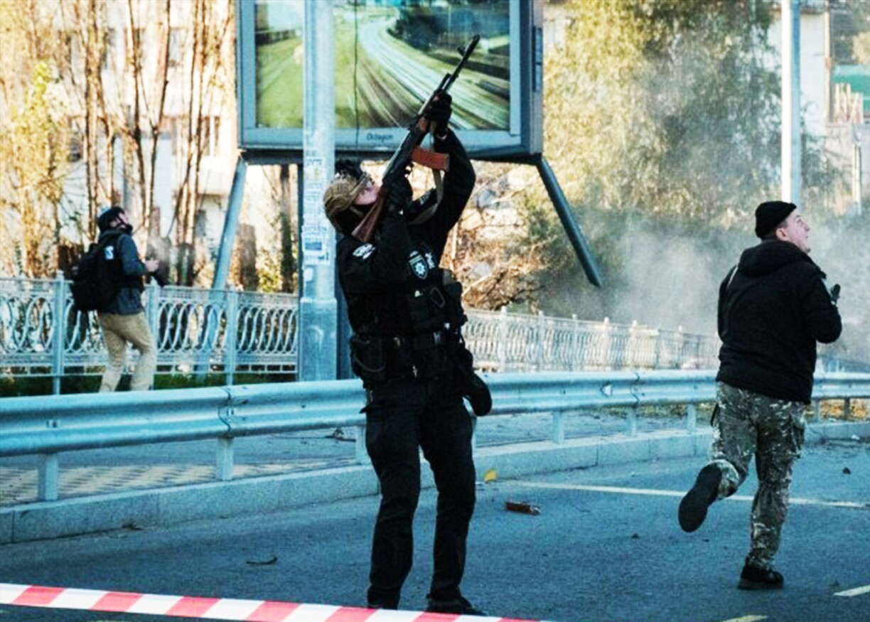 A police officer fires at a flying drone in Kyiv, Ukraine.