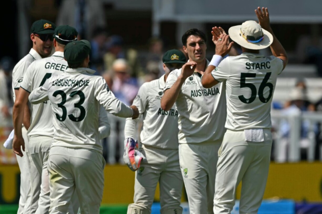 Australia captain Pat Cummins (2R) celebrates with team-mates after dismissing South Africa skipper Temba Bavuma in the WTC final at Lord's
