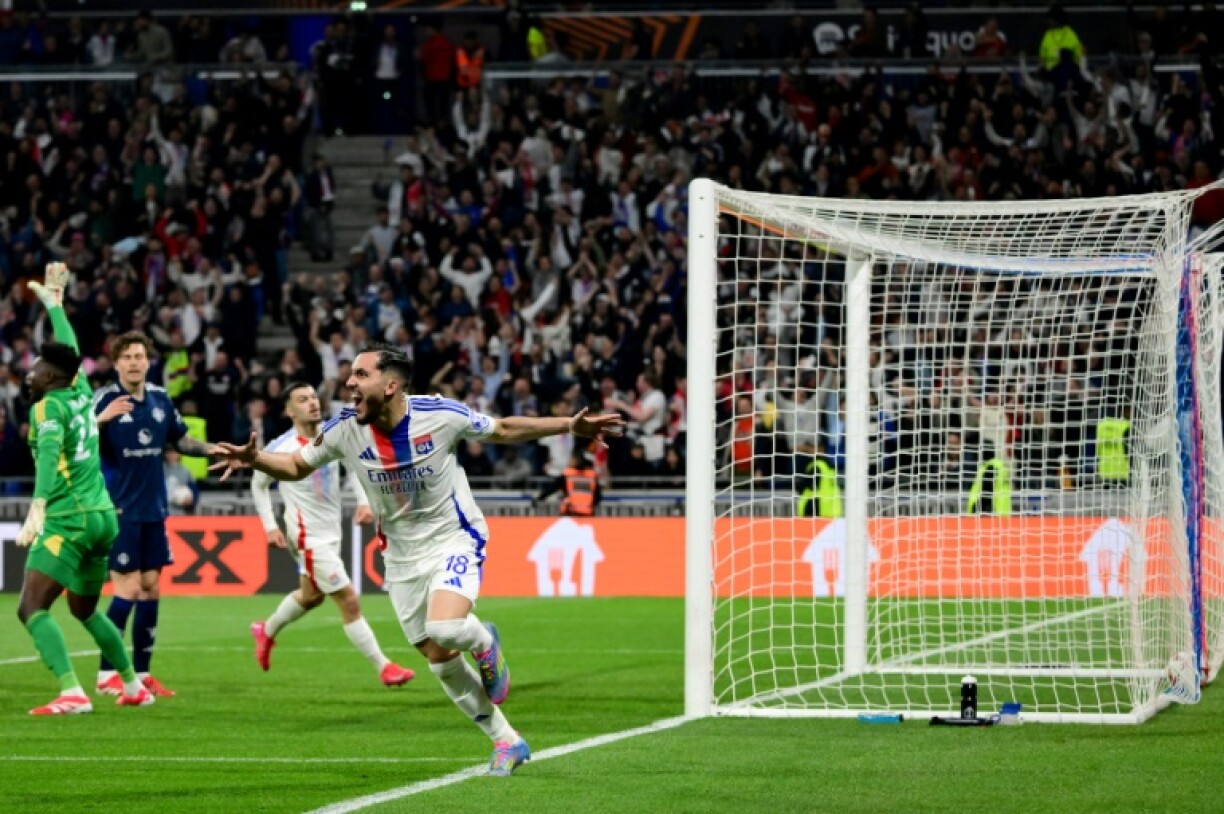 Rayan Cherki (C) celebrates his late Europa League equaliser for Lyon as United goalkeeper Andre Onana (L) appeals